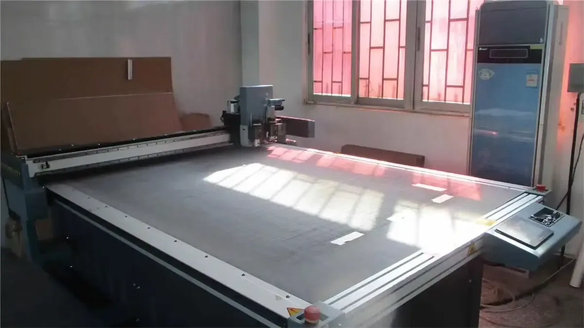 Vacuum-bed sample cutter used to prove custom dielines before a scratcher goes to bulk tooling.