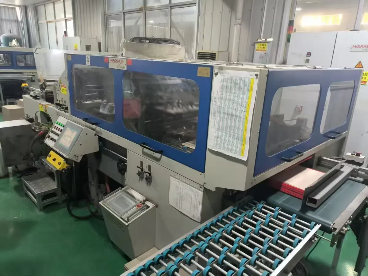 Folder-gluer running compact cartons, turning flat board into neat packs for cat products.