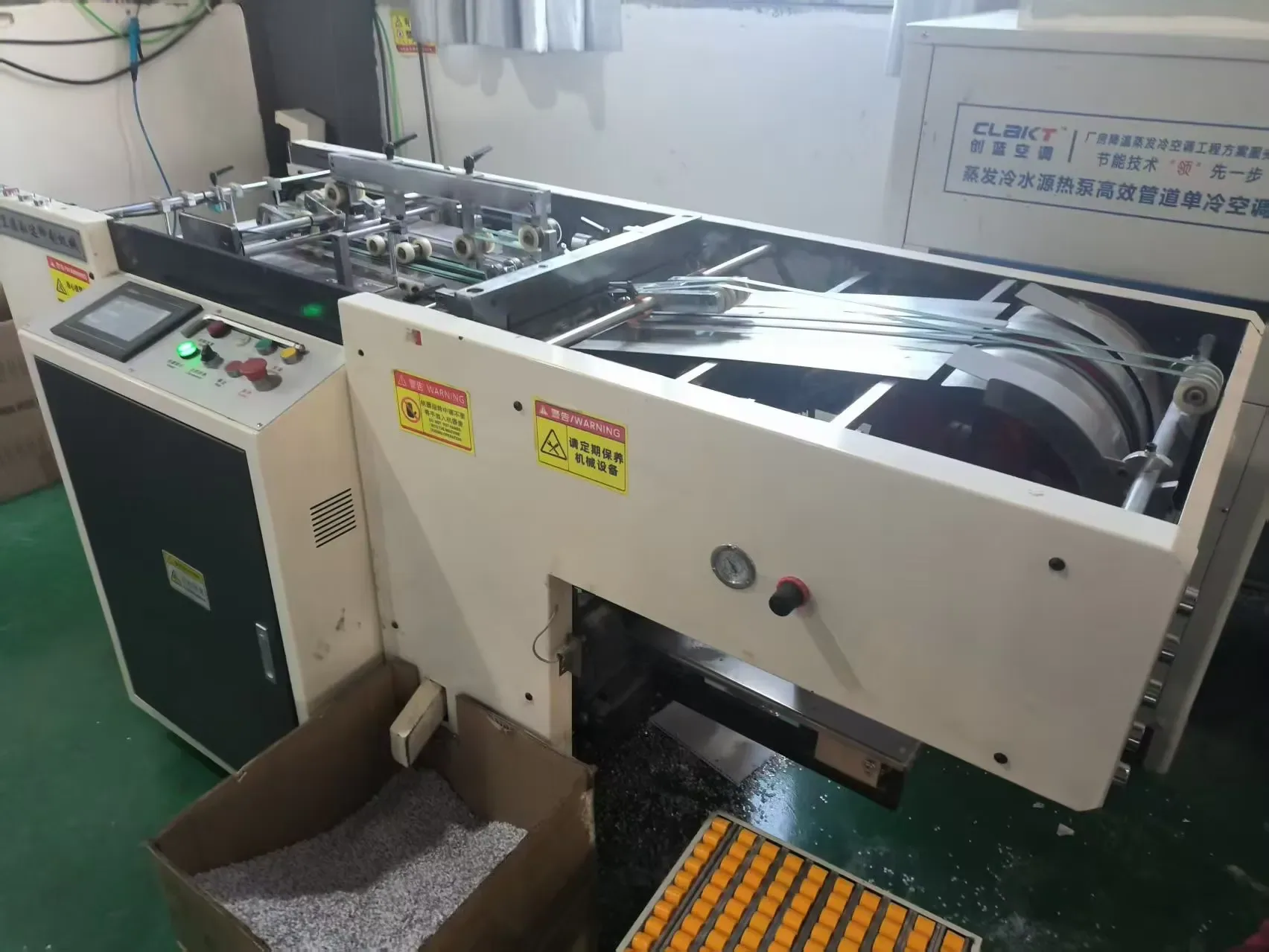 Sheet laminator bonding decorative faces to board with an even adhesive laydown.