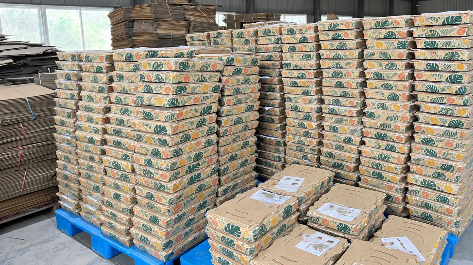 Finished scratcher cartons stacked for dispatch, pallet after pallet of retail-ready cat furniture.