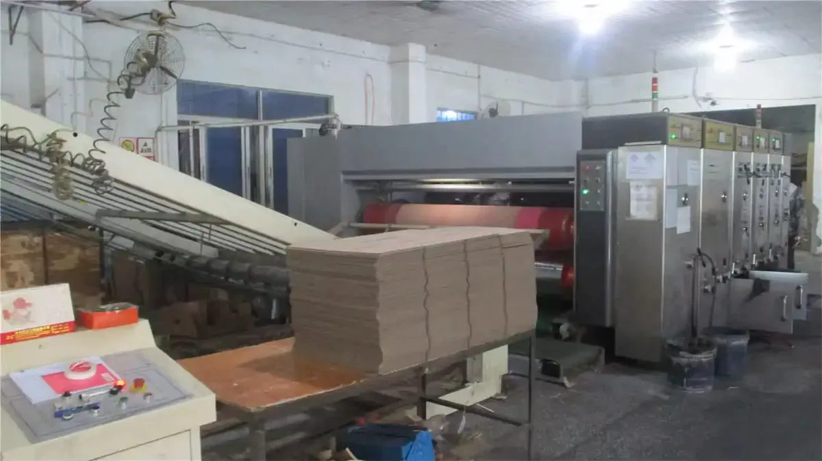 Freshly printed corrugated sheets stacked at press delivery, ready for die-cutting into cat furniture.