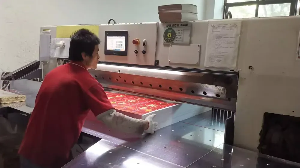 An operator proofing color on the inspection table before a scratcher print run is approved.