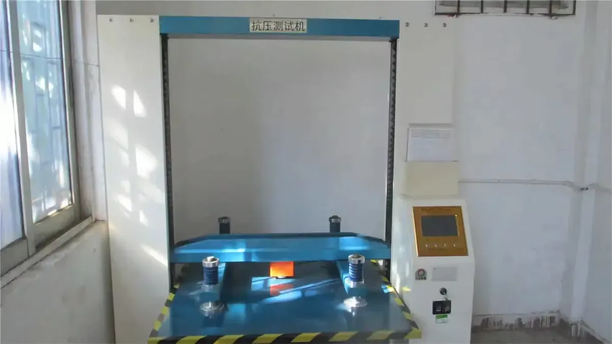 Compression tester for export carton strength, pressing sample board the way a stacked shipment will.