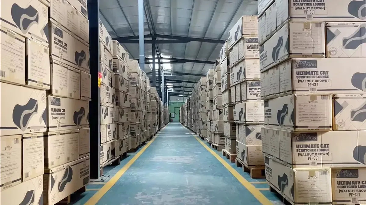 Branded cat scratcher cartons lining a long export aisle, packed and waiting for the next outbound load.