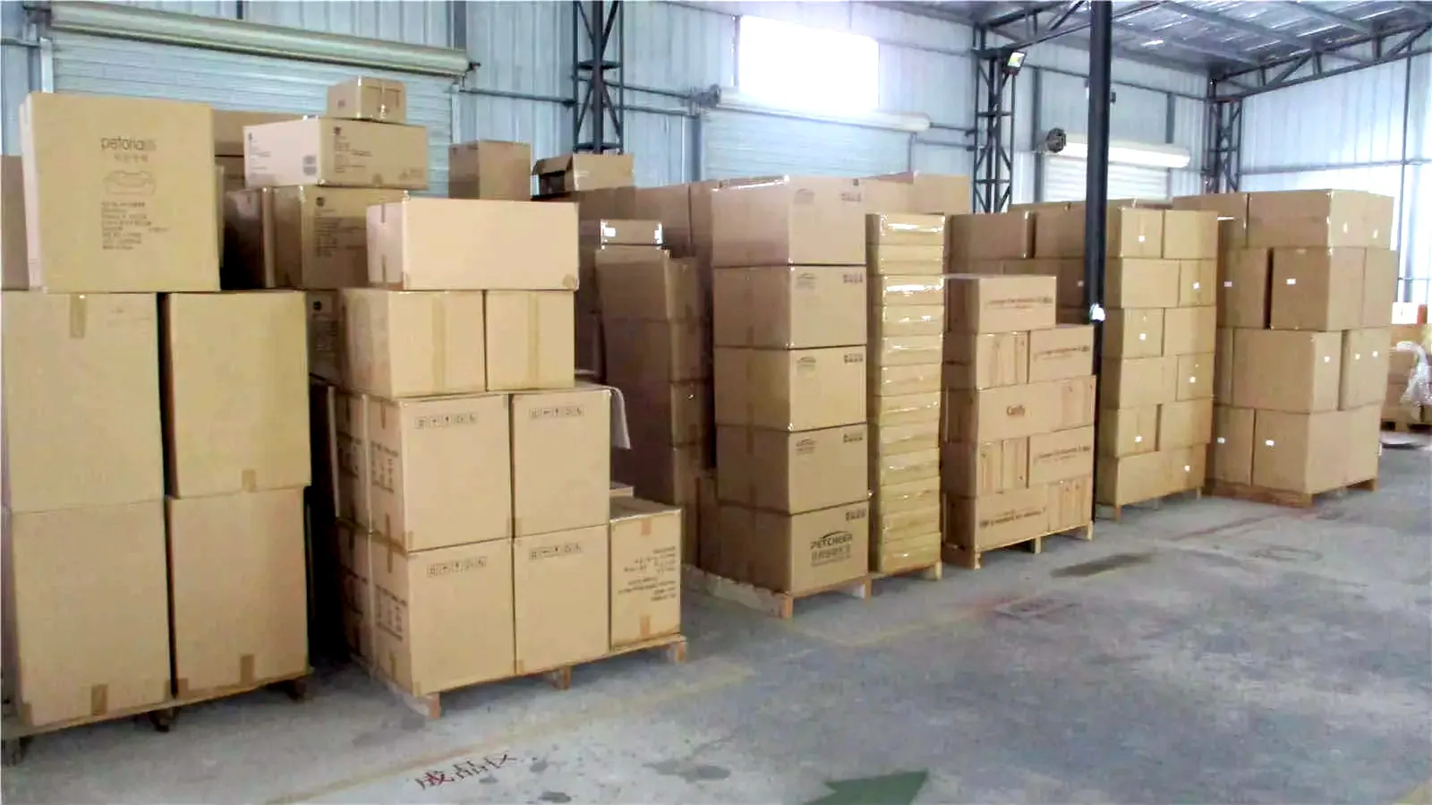 Shipping cartons built up for a full load, a solid block of finished cat products in the plant warehouse.