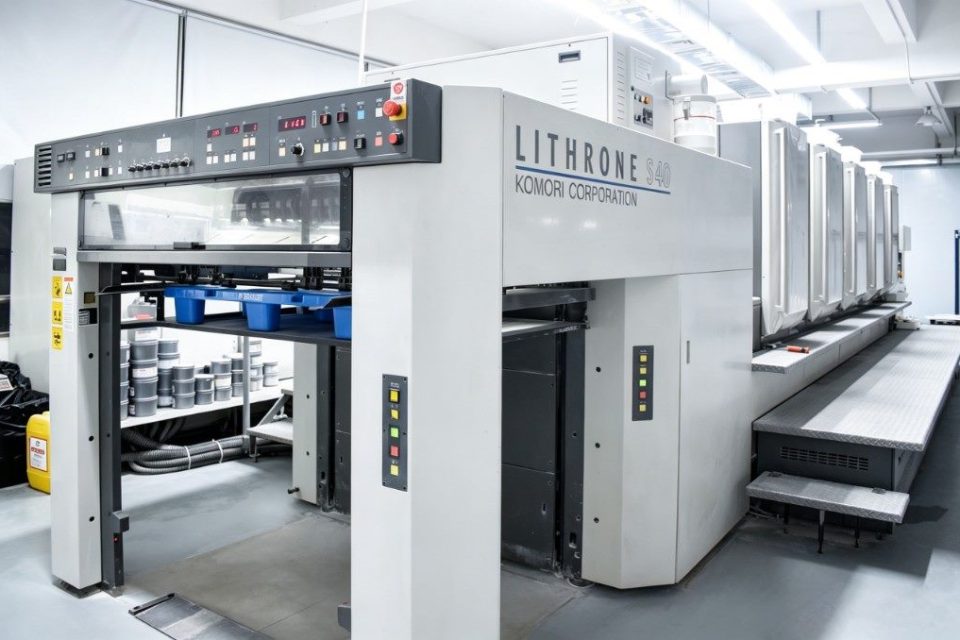 The Komori offset press line inside the plant, printing crisp brand artwork onto corrugated board.